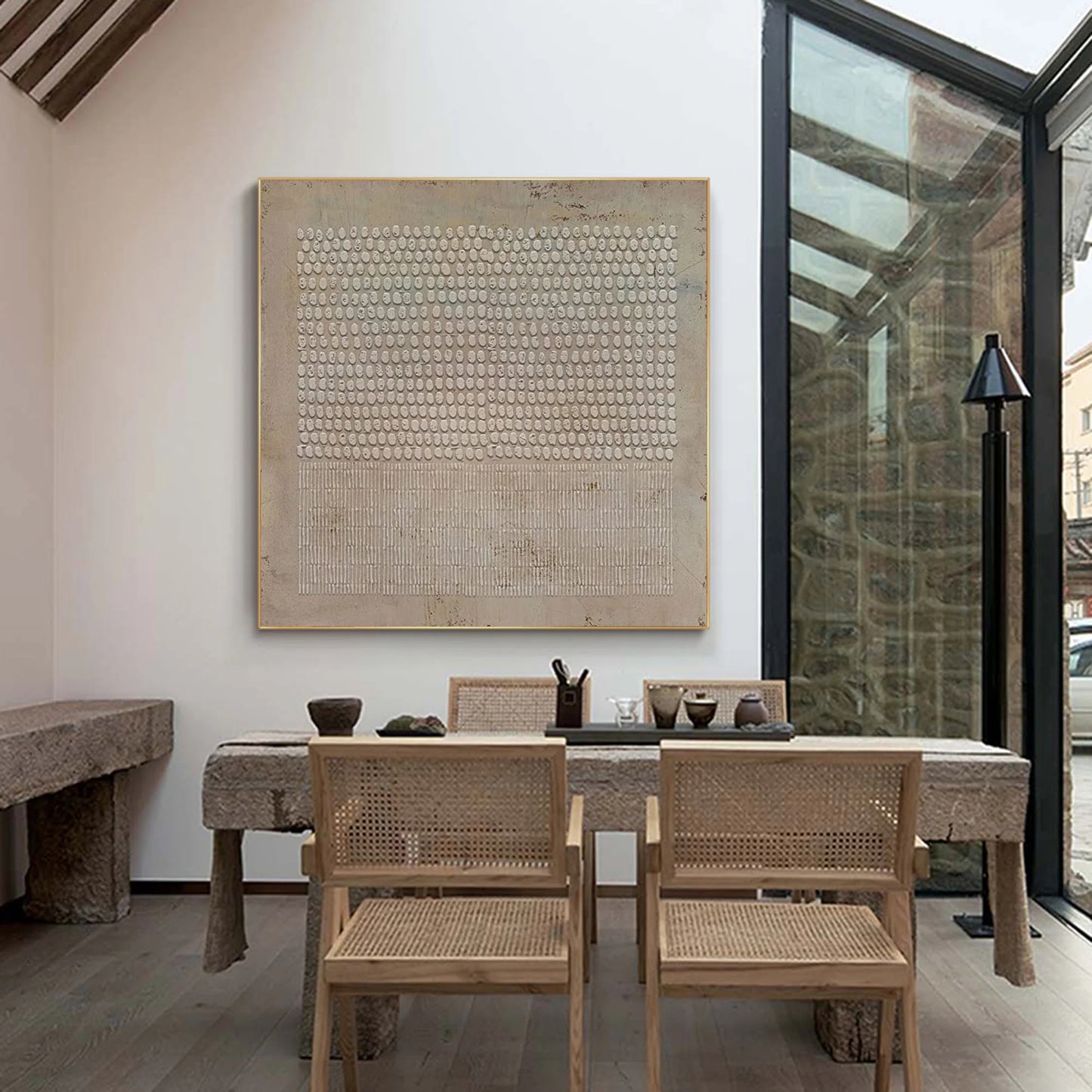 Beige abstract canvas with raised patterns shown in neutral interior.