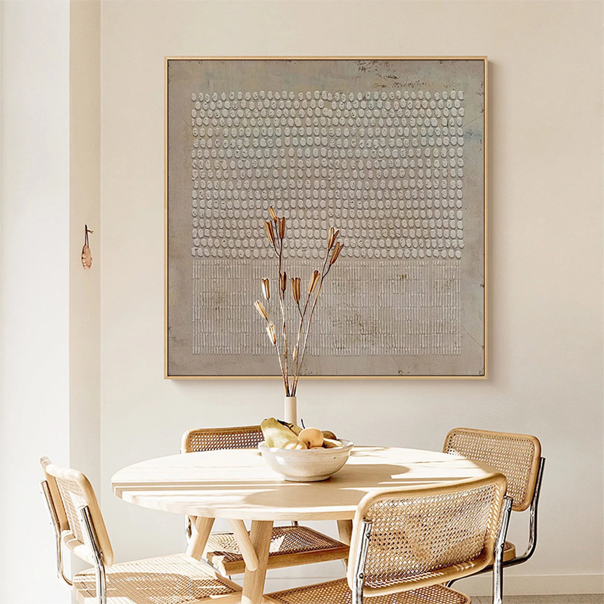 Soft beige Wabi-Sabi abstract art in cozy reading corner.